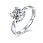 CARISSIE round moissanite solitaire ring, angled view showing split shank band with pavé accents and halo setting
