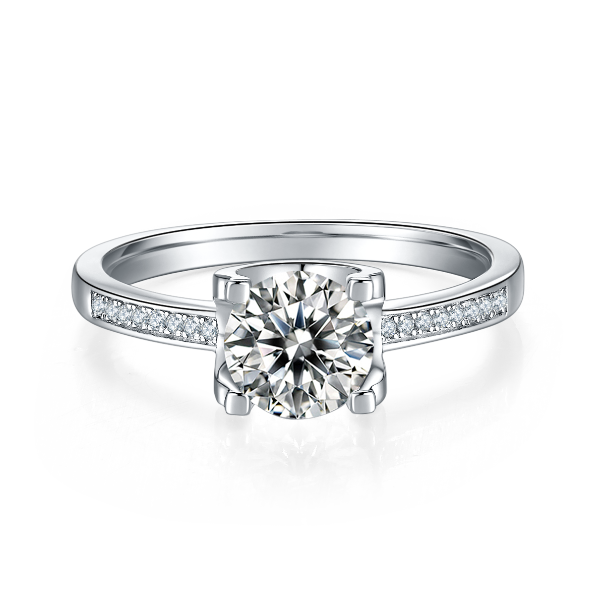 CARISSIE round moissanite solitaire ring, front view highlighting four-prong setting and channel-set accents