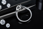 CARISSIE round moissanite tension ring, detailed side angle revealing the inner band stamping and precise craftsmanship