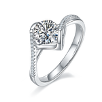 CARISSIE round moissanite bezel ring, angled view highlighting the wave-like metal frame and pavé split shank band.