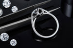CARISSIE round moissanite bezel ring, macro detail shot displaying the inner band structure next to tweezers.