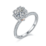 CARISSIE round moissanite halo ring, angled view highlighting the split shank band and rose gold accent at the base.