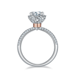 CARISSIE round moissanite halo ring, side profile revealing a heart-shaped cutout in the gallery and rose gold wrapping.