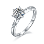 CARISSIE round moissanite solitaire ring, angled view showing split shank band with pavé accents and brilliant center stone