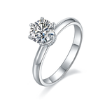 CARISSIE round moissanite solitaire ring, angled view highlighting the split-shank band and pavé basket details