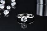 CARISSIE round moissanite solitaire ring, close-up top-down view emphasizing the sparkle of the center gem