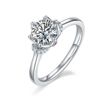 CARISSIE round moissanite solitaire ring, angled view highlighting six-prong setting and hidden pink stone detail