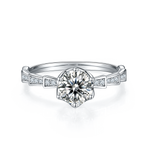 CARISSIE round moissanite solitaire ring, front view showcasing the brilliant cut center stone held by four prongs in silver-tone metal
