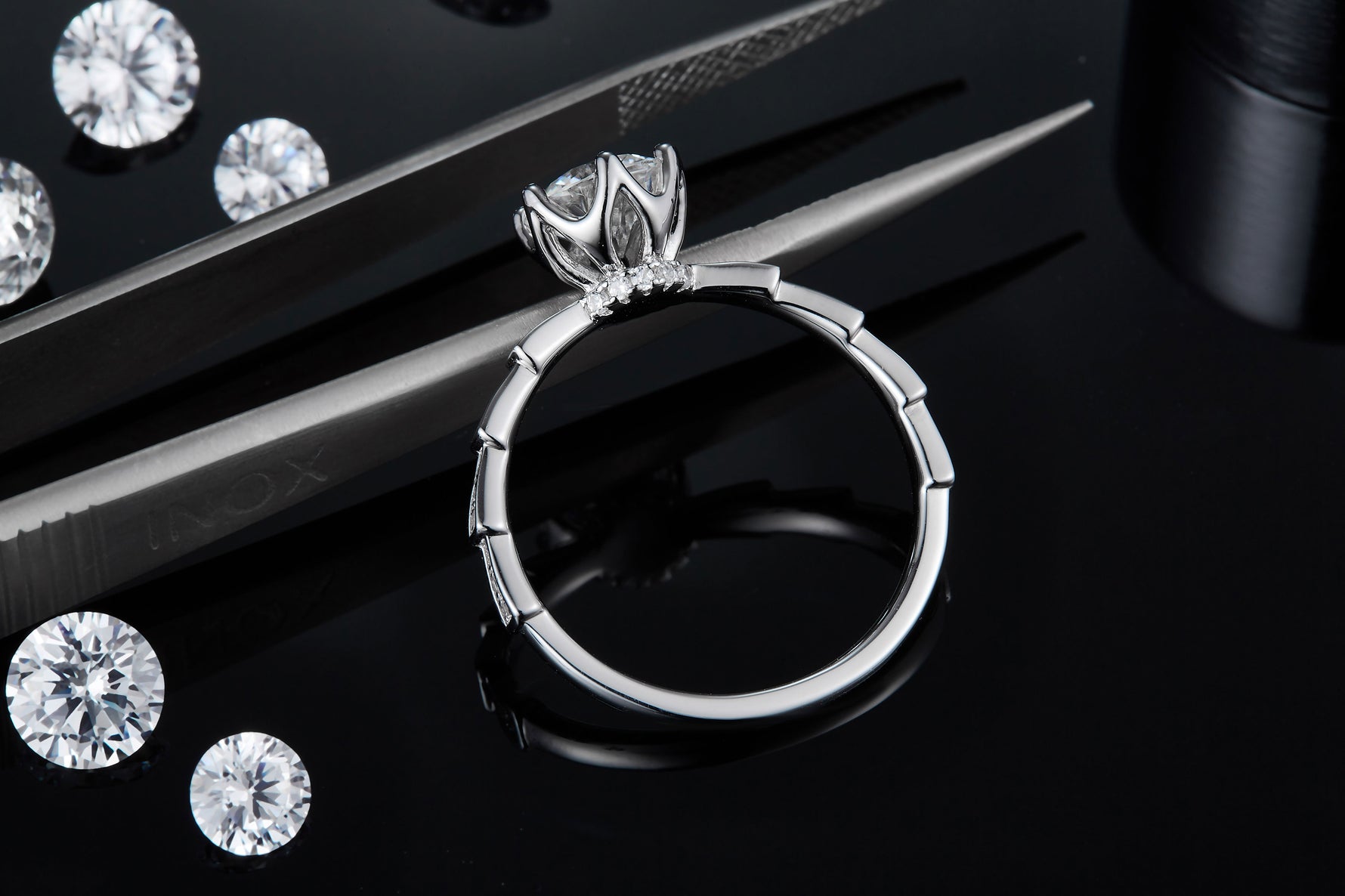CARISSIE round moissanite solitaire ring, close-up macro view showing the precision craftsmanship of the openwork gallery under the stone
