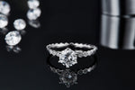 CARISSIE round moissanite solitaire ring, lifestyle shot with reflection showing the center stone brilliance and textured details