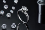 CARISSIE round moissanite solitaire ring, side profile shot on black background displaying the detailed under-gallery design