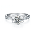 CARISSIE round moissanite solitaire ring, top-down perspective showing the brilliant center stone and floral prong setting