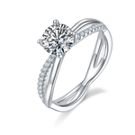 CARISSIE round moissanite solitaire ring, angled view showing split shank band with pavé accents and brilliant center stone