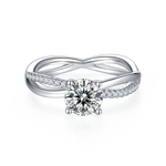 CARISSIE round moissanite solitaire ring, top-down view displaying the four-prong setting and symmetrical pavé detailing on the band