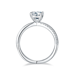 CARISSIE round moissanite solitaire ring, side profile highlighting the split shank design and row of accent stones along the band