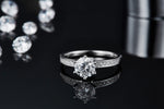 CARISSIE round moissanite solitaire ring, close-up on black mirror displaying the clear reflection of the silver-tone setting