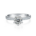 CARISSIE round moissanite solitaire ring, front view highlighting the brilliant center stone and channel-set band shoulders