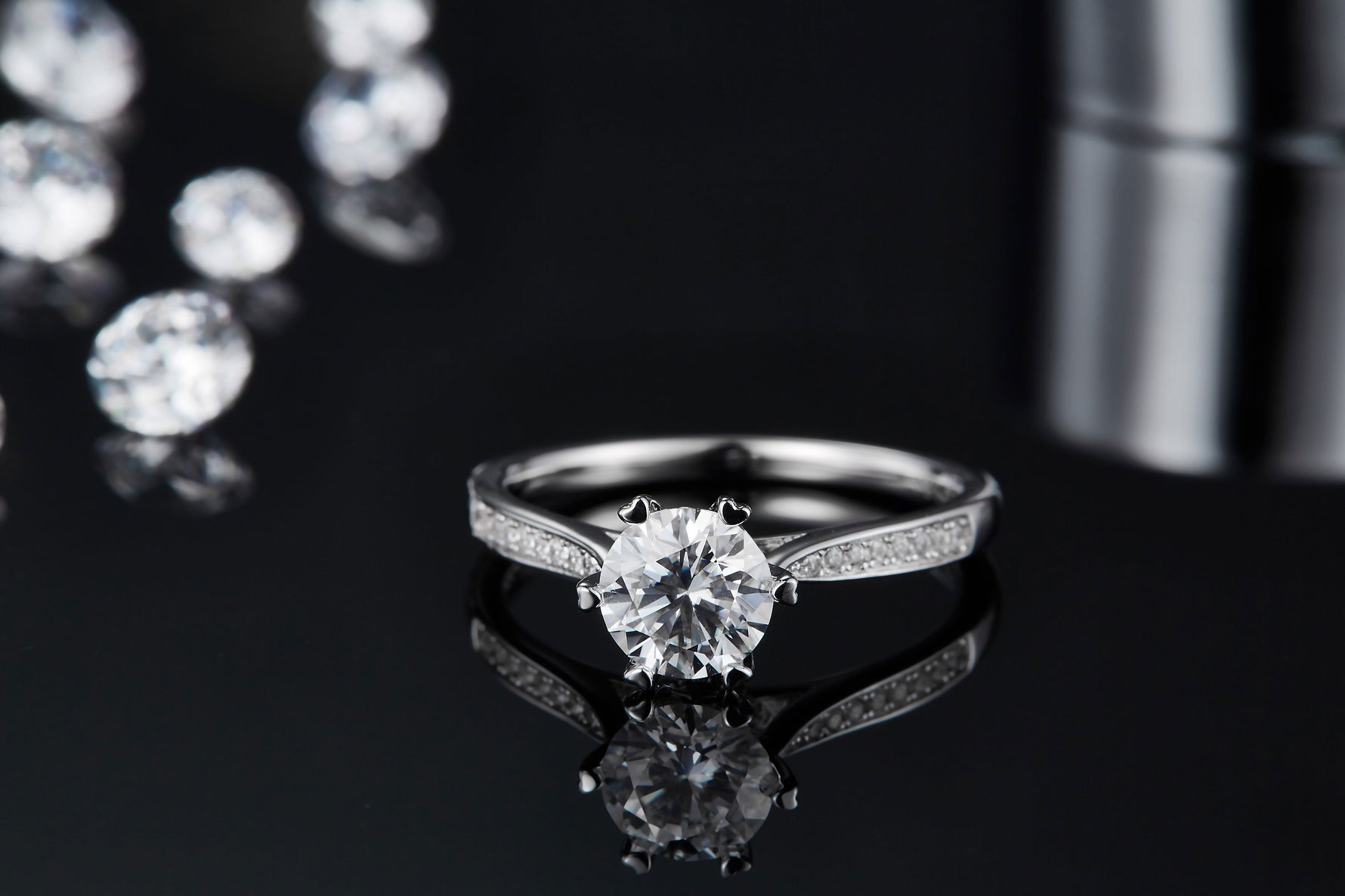 CARISSIE round moissanite solitaire ring, top-down view emphasizing sparkle of center stone and symmetrical shoulder details