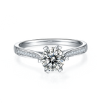CARISSIE round moissanite solitaire ring, front view showing brilliant center stone in silver-tone prong setting