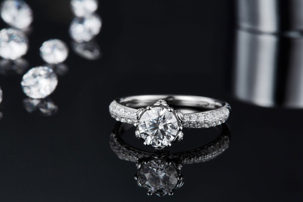 CARISSIE round moissanite solitaire ring, low-angle close-up showcasing the sparkle of the center stone