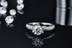 CARISSIE round moissanite solitaire ring, low-angle close-up showcasing the sparkle of the center stone
