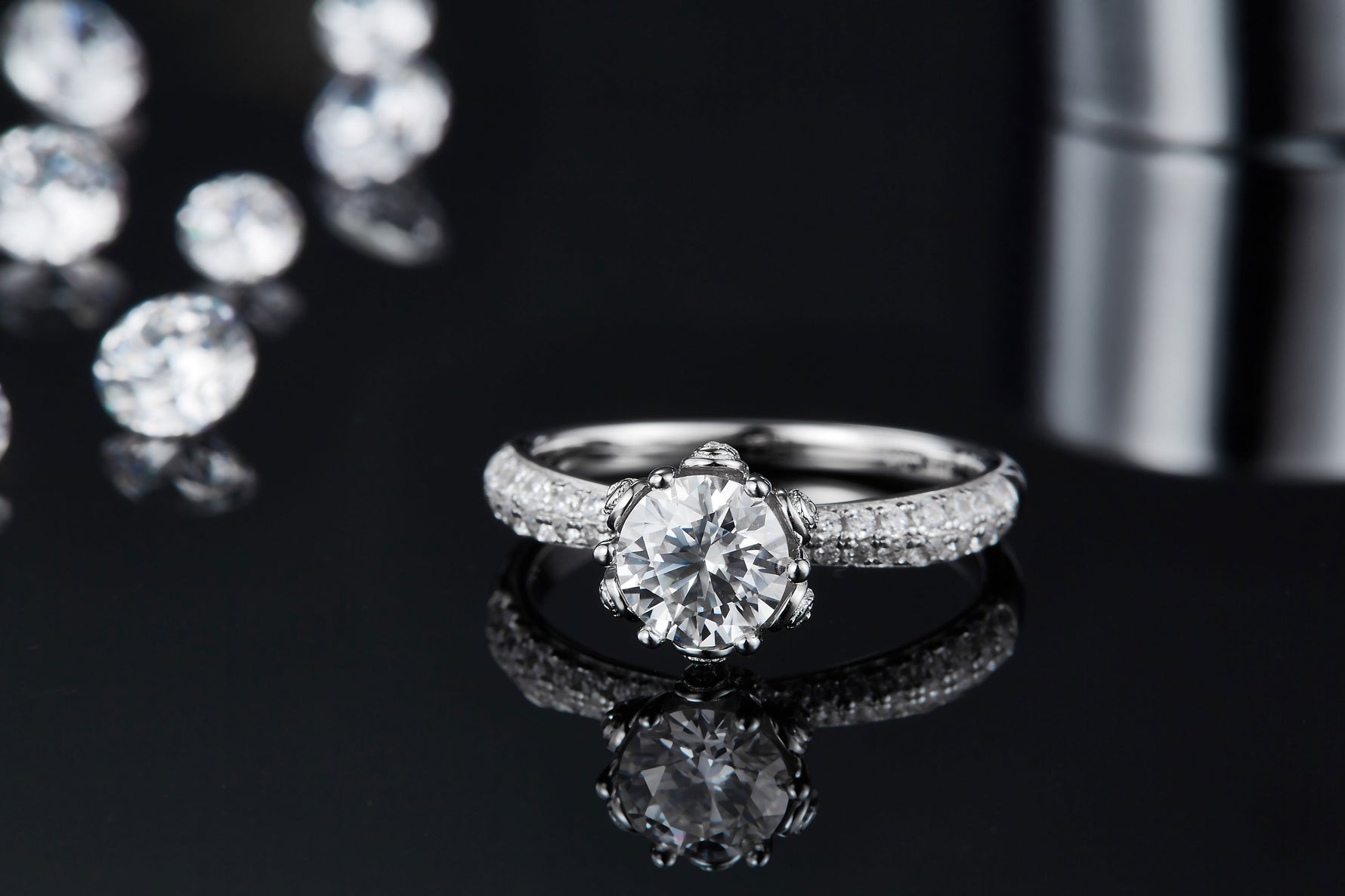 CARISSIE round moissanite solitaire ring, low-angle close-up showcasing the sparkle of the center stone