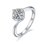 CARISSIE round moissanite solitaire ring, angled view showing twisted shank and brilliant center stone in four-prong setting