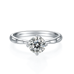 CARISSIE round moissanite solitaire ring, top-down view showing the brilliant-cut center stone and four-prong setting