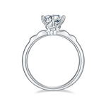 CARISSIE round moissanite solitaire ring, side profile revealing the undulating band design and smooth inner shank