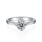 CARISSIE round moissanite solitaire ring, front view highlighting four-prong setting and high-polish silver metal