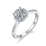 CARISSIE round moissanite halo engagement ring, angled view highlighting pavé accents on the silver-tone band shoulders
