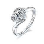 CARISSIE round moissanite engagement ring, angled view highlighting the split shank band and heart-shaped halo setting