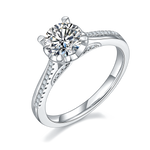 CARISSIE round moissanite solitaire ring, angled view showing split shank band with pavé accents and brilliant center stone