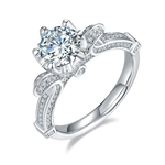 CARISSIE round moissanite solitaire ring, angled view showing split shank band with pavé accents and prong setting