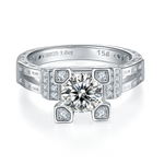 CARISSIE round moissanite solitaire ring, front view highlighting the central stone flanked by pavé diamond accents on silver band