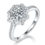 CARISSIE round moissanite halo ring, angled view highlighting the floral petal design and pavé diamond band