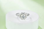 CARISSIE round moissanite halo ring, elevated display on a white podium showcasing the full vintage aesthetic