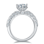 CARISSIE round moissanite solitaire ring, top-down view displaying the circular band and leaf-like stone details