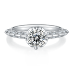 CARISSIE round moissanite solitaire ring, low front angle highlighting the split shank design and four-prong setting