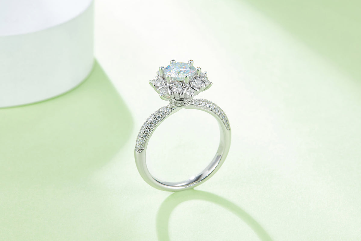 CARISSIE round moissanite cluster engagement ring, elevated angle displaying the high-set head and curved band
