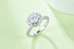 CARISSIE round moissanite cluster engagement ring, lifestyle shot on soft green background emphasizing brilliance