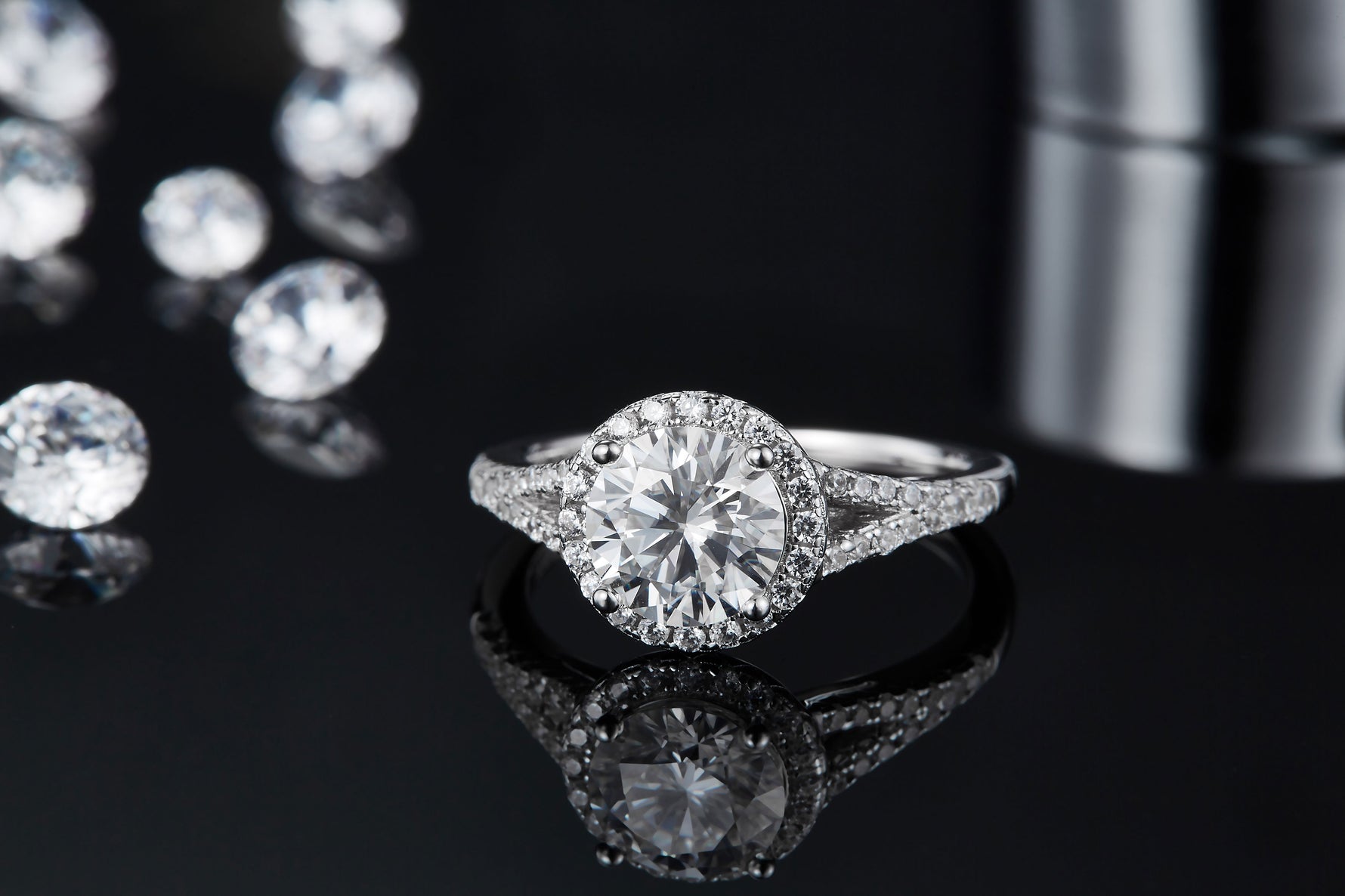 CARISSIE round moissanite halo engagement ring, close-up top view displaying brilliant cut facets and prong setting