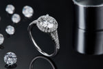 CARISSIE round moissanite halo ring, lifestyle shot with dark background emphasizing the sparkle of the white metal setting