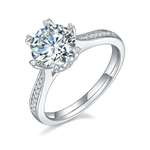 CARISSIE round moissanite solitaire ring, angled view showing split shank band with pavé accents and brilliant center stone
