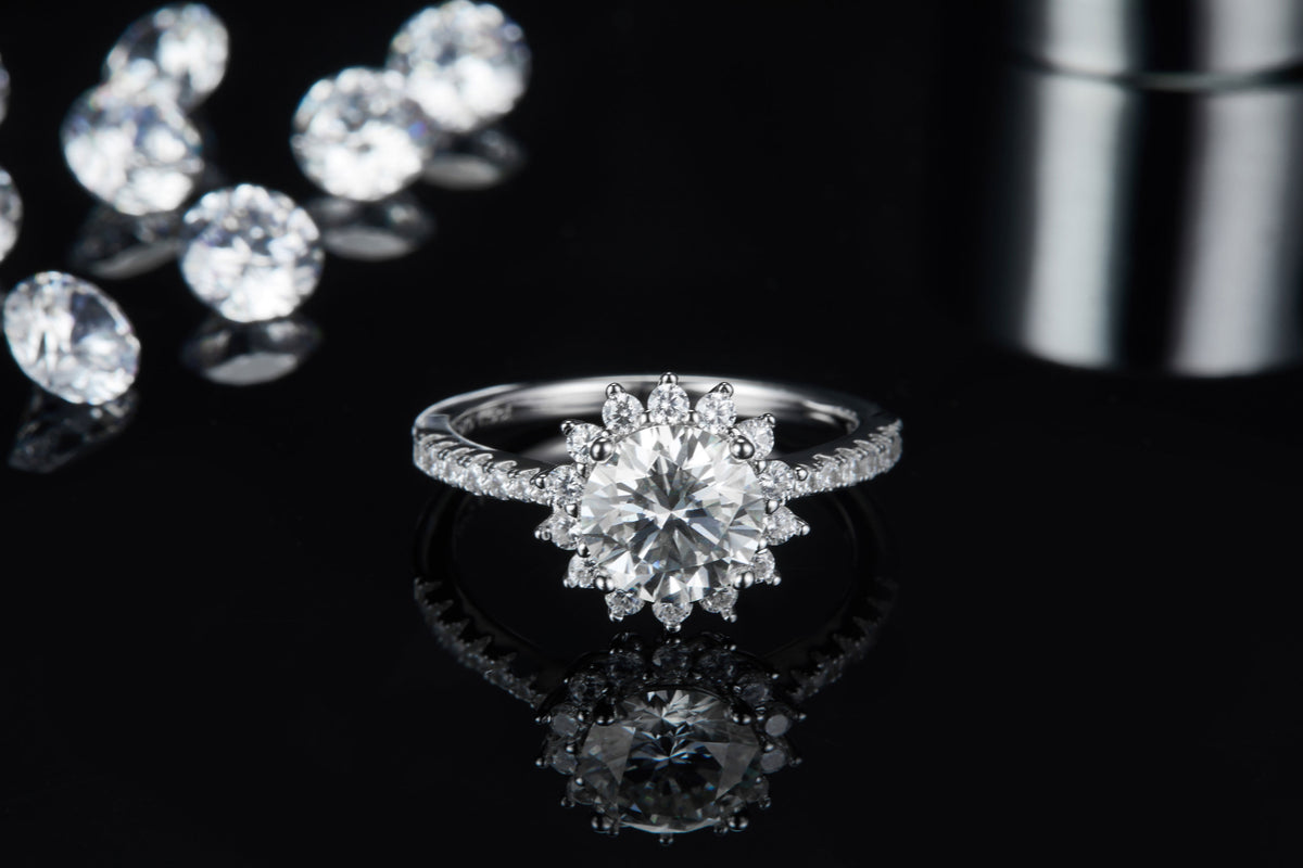 CARISSIE round moissanite halo engagement ring, centered view showing the full sparkle of the silver-tone metal and halo design.