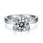 CARISSIE round moissanite solitaire ring, front view highlighting the brilliant-cut center stone in a classic prong setting