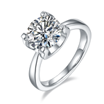 CARISSIE round moissanite solitaire ring, angled view showing high-polish silver band and four-prong setting