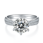 CARISSIE round moissanite solitaire ring, top-down view highlighting six-prong setting and dual rows of accent stones