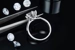 CARISSIE round moissanite solitaire ring, detailed angle showing craftsmanship near tweezers and interior hallmarks