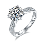 CARISSIE round moissanite solitaire ring, angled view showing split shank band with pavé stones and S925 stamp